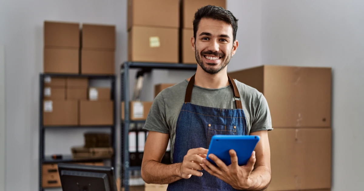 Young man in warehouse using a tablet