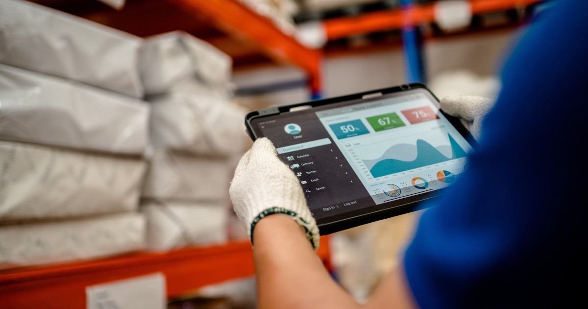 Closeup of warehouse worker using tablet