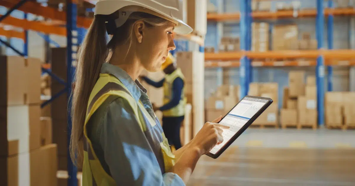Woman in warehouse using a tablet